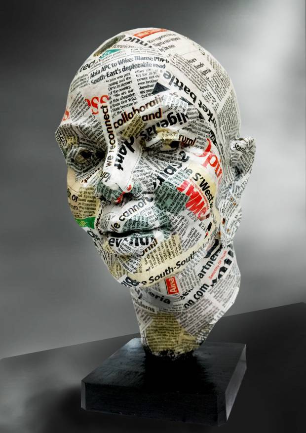 Sculpture head covered in colorful newsprint